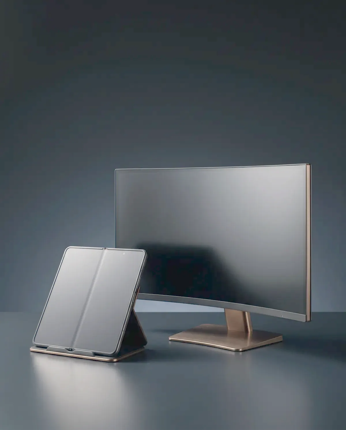Illustrative photograph of a foldable smartphone and a curved monitor