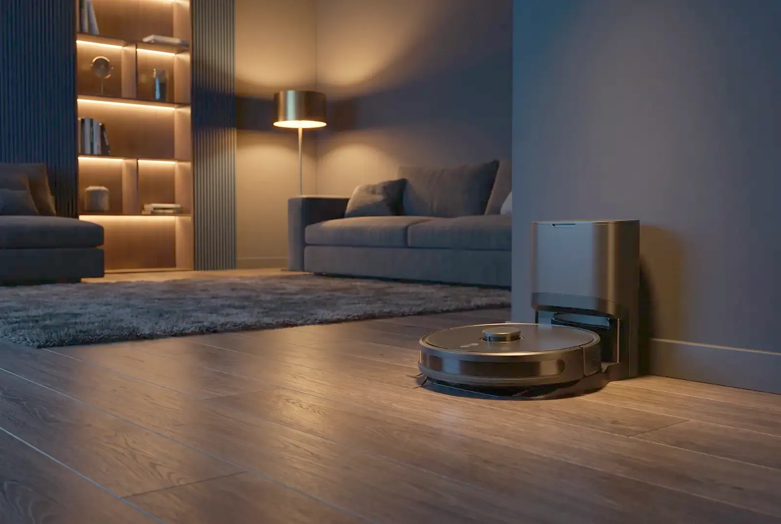 A robot vacuum cleaner beside its docking station on an oak floor