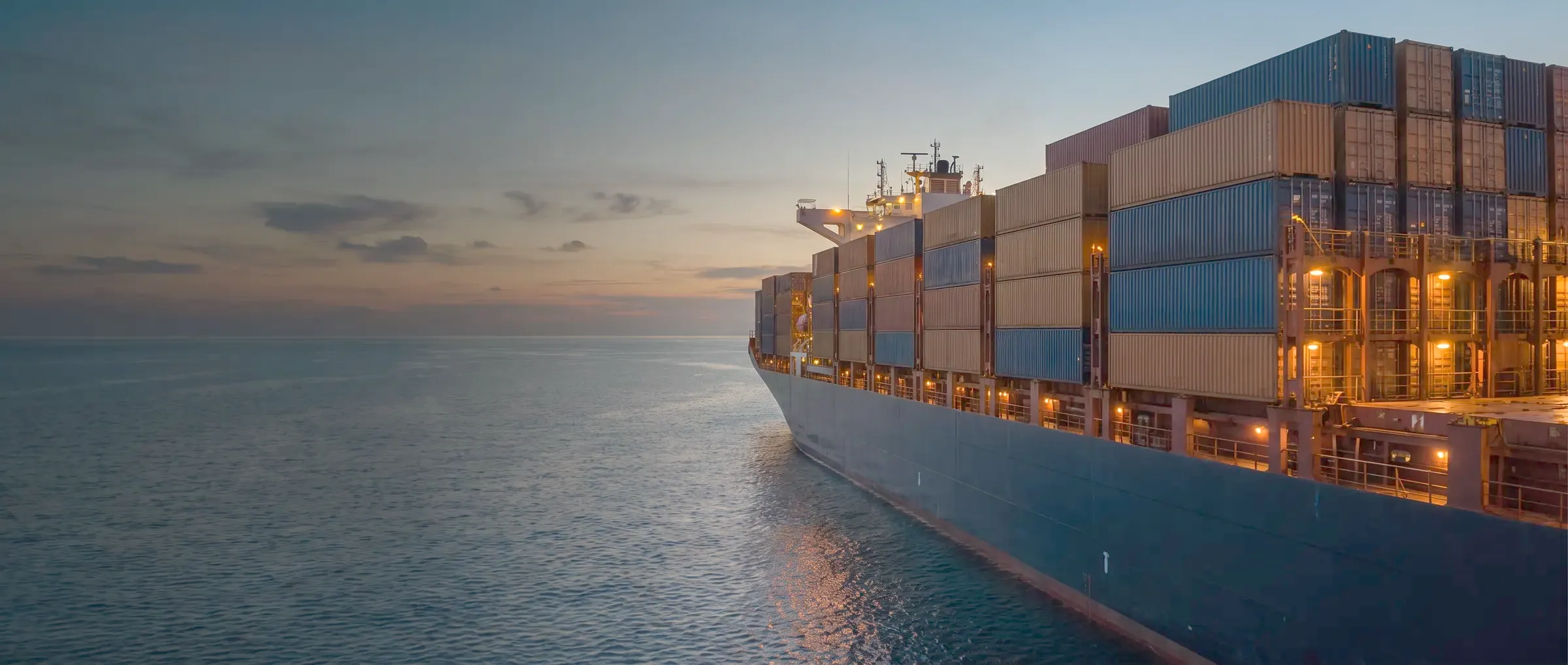 Container vessel at sea at dusk